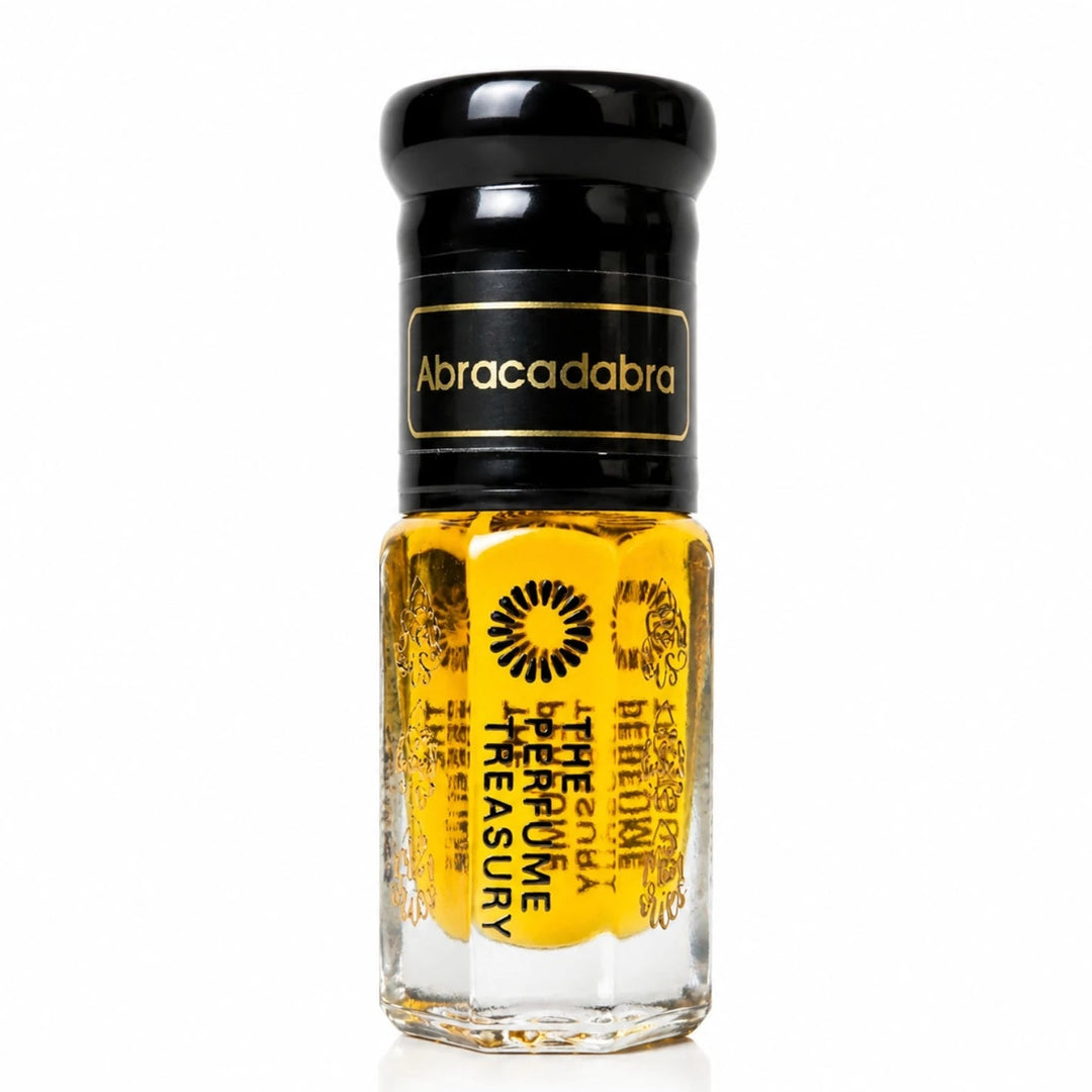 Close-up macro of Abracadabra concentrated perfume oil bottle by The Perfume Treasury, showing luminous golden oil texture and premium glass styling, concentrated perfume oil in clear glass bottle with black cap.