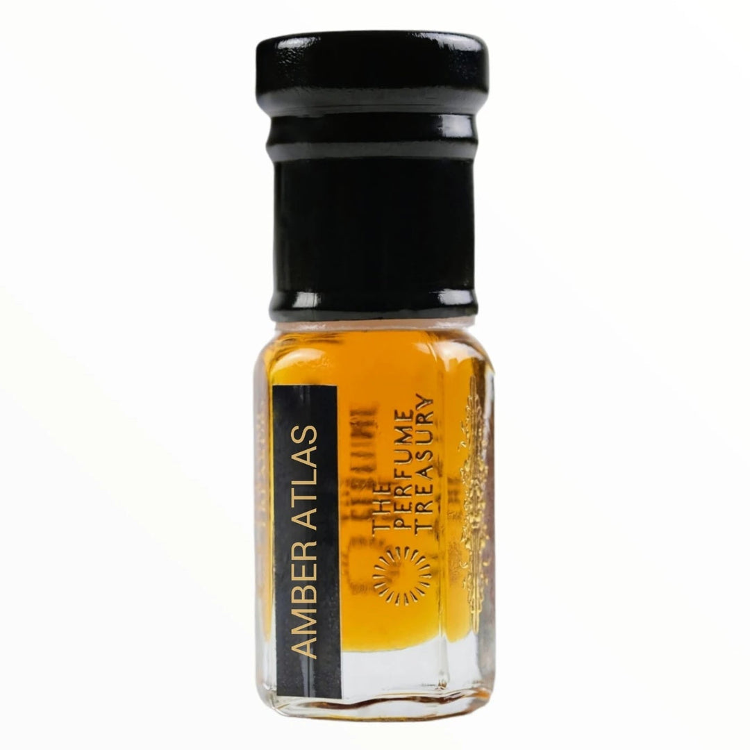 Close-up macro of Amber Atlas perfume oil bottle by The Perfume Treasury, showing warm amber oil texture and reflective clear glass finish, concentrated perfume oil in clear glass bottle with black cap.
