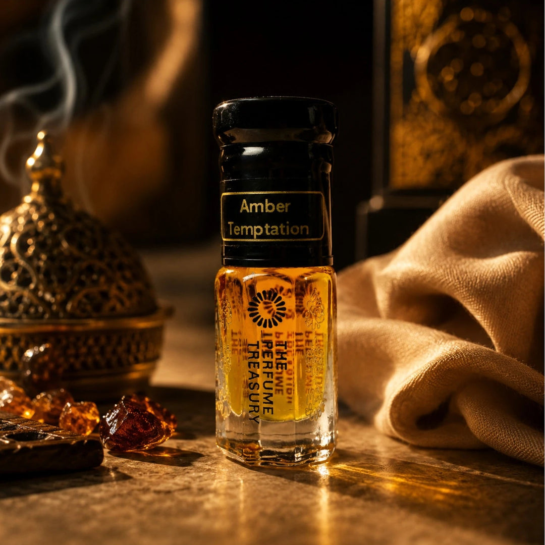 Luxury lifestyle photograph of Amber Temptation perfume oil bottle with incense smoke, amber resin crystals and golden satin fabric, highlighting warm oriental fragrance ambiance and elegant Arabian perfume presentation.