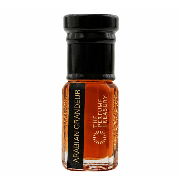 Minimal studio product shot of Arabian Grandeur perfume oil featuring deep amber-red attar oil in a crystal-clear glass bottle with black cap and refined branding on white background.
