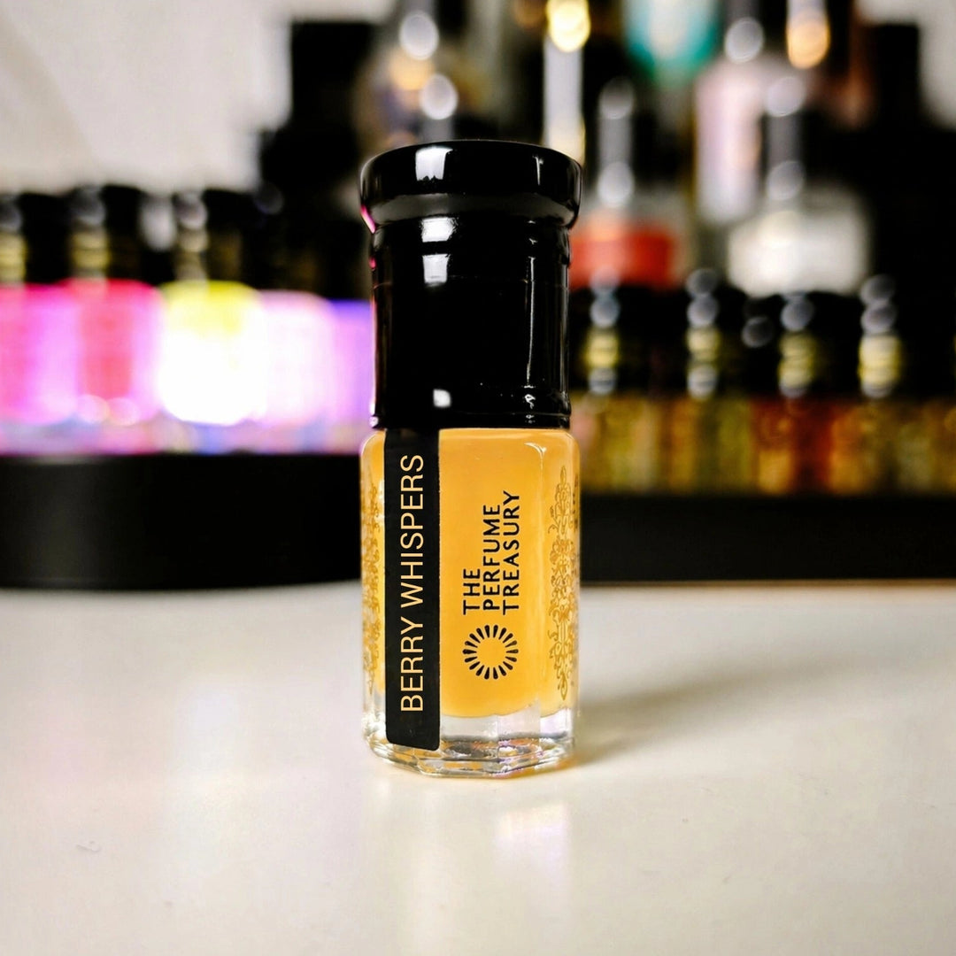 Luxury lifestyle image of Berry Whispers musk perfume oil bottle displayed on a clean surface with softly blurred colorful perfume bottles in the background, creating a premium boutique fragrance atmosphere.