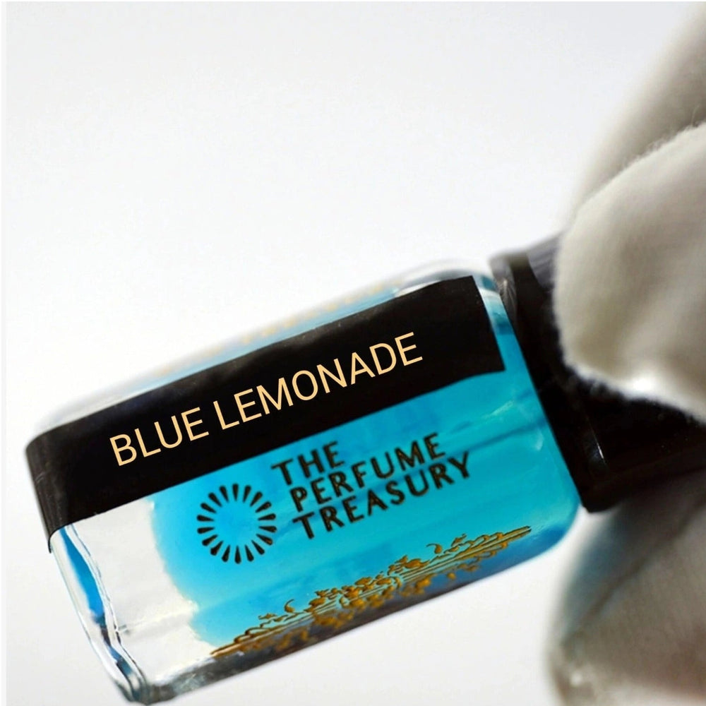 Close-up of Blue Lemonade musk perfume oil bottle held in white glove, showcasing bright aquatic blue fragrance oil by The Perfume Treasury.