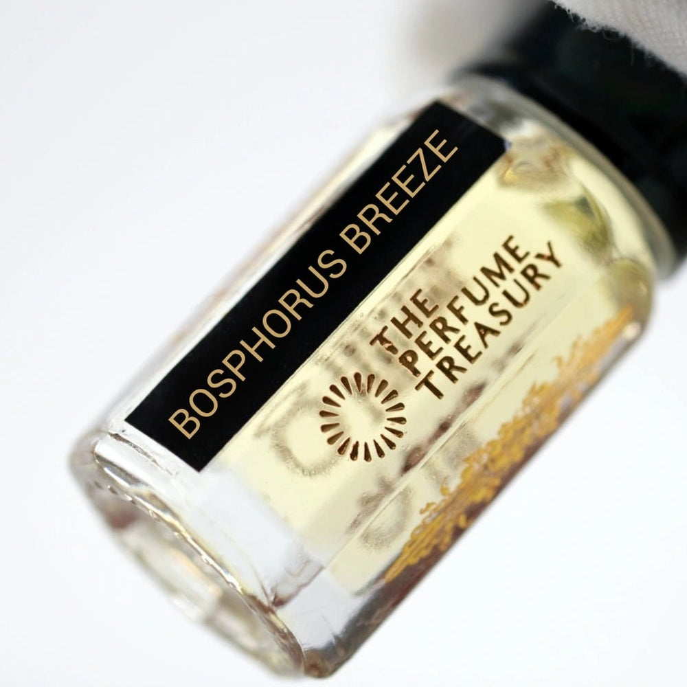 Close-up of Bosphorus Breeze perfume oil bottle held in white glove, showcasing luxury concentrated fragrance oil by The Perfume Treasury.