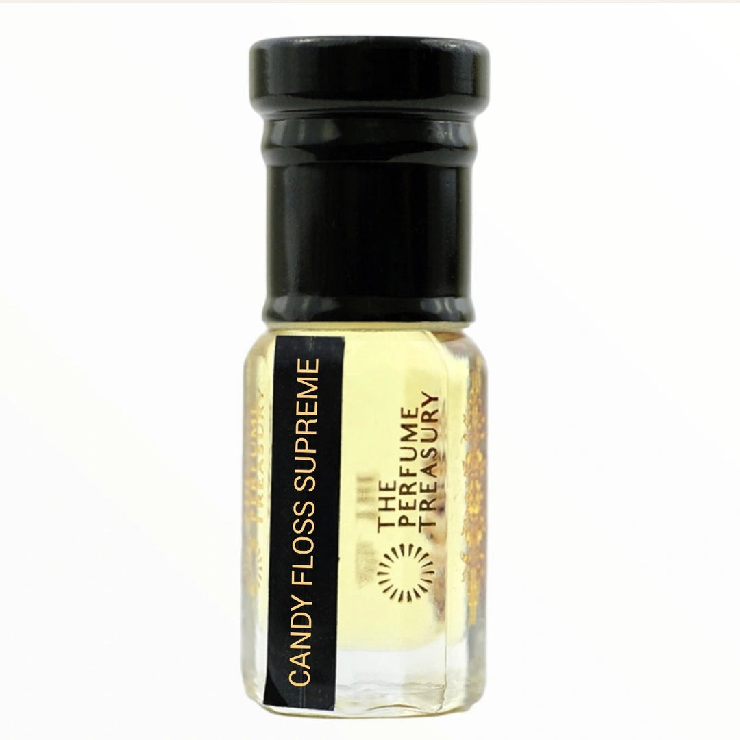Small clear glass perfume oil bottle with black cap, Candy Floss Supreme 3ml attar perfume oil by The Perfume Treasury, light sweet fragrance oil on white background.