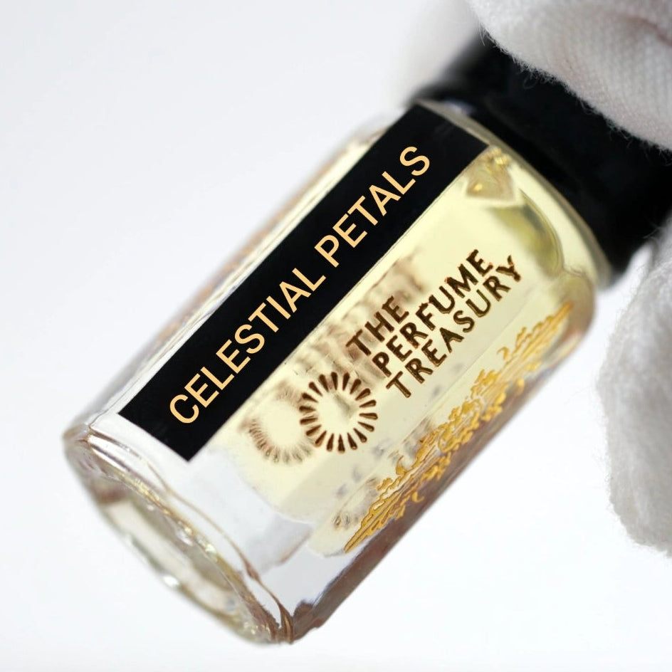 Close-up of Celestial Petals perfume oil bottle held with white glove showcasing elegant luxury fragrance branding.
