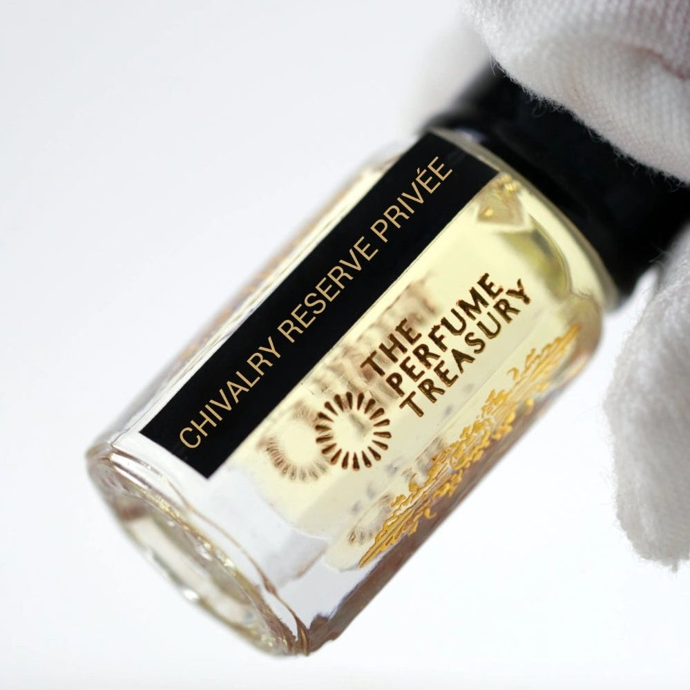 Chivalry Reserve Privée perfume oil bottle close-up held with white glove in elegant minimalist luxury style.