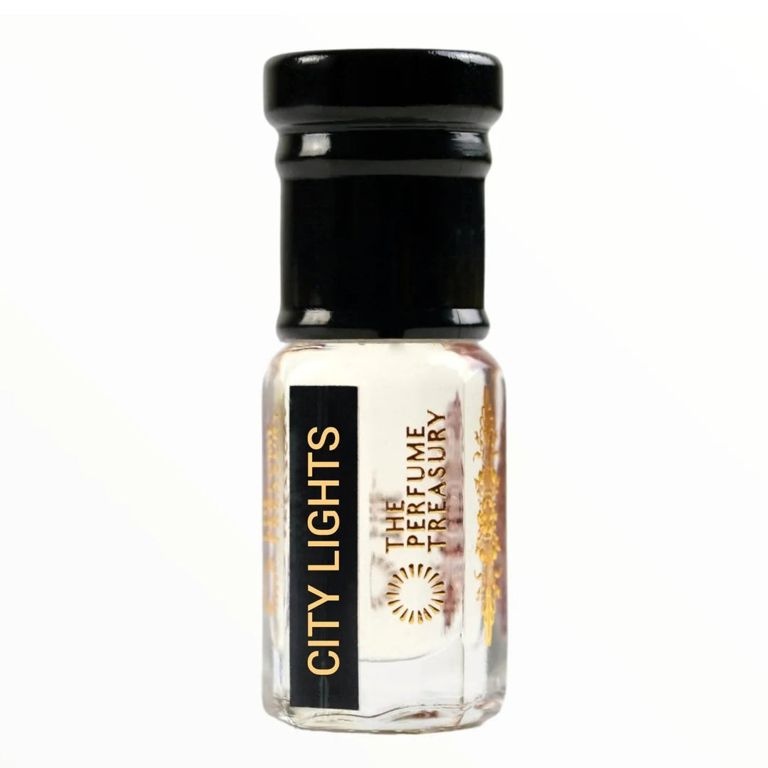 Small clear glass perfume oil bottle with black cap, City Lights 3ml attar perfume oil by The Perfume Treasury, clear fresh fragrance oil on white background.