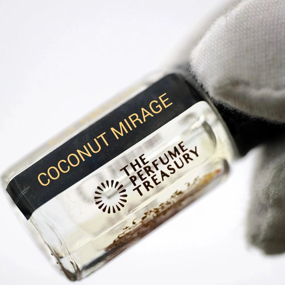 Close-up of Coconut Mirage luxury perfume oil bottle held with white glove showcasing premium niche fragrance presentation and elegant gold branding details.