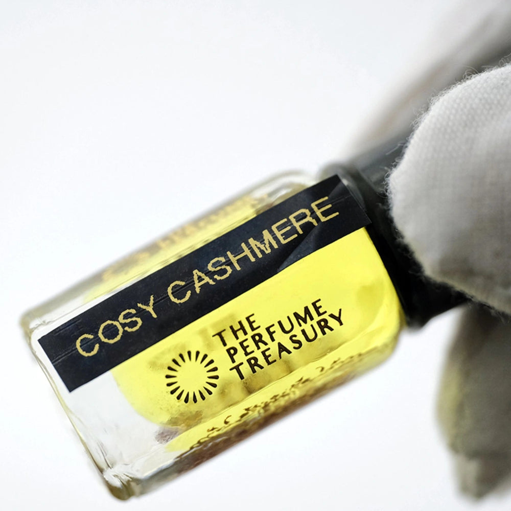 Close-up detail of Cosy Cashmere perfume oil by The Perfume Treasury, highlighting the luxury glass bottle, concentrated fragrance oil and premium label design.
