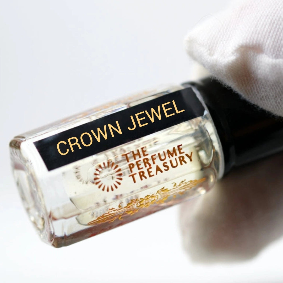Close-up of Crown Jewel perfume oil by The Perfume Treasury held in hand, showcasing the premium glass bottle, concentrated fragrance oil and elegant label details.