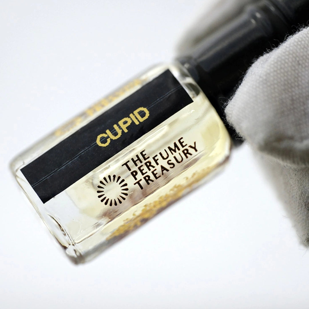 Close-up detail of Cupid perfume oil by The Perfume Treasury, highlighting the luxury glass bottle, concentrated fragrance oil and premium label design.