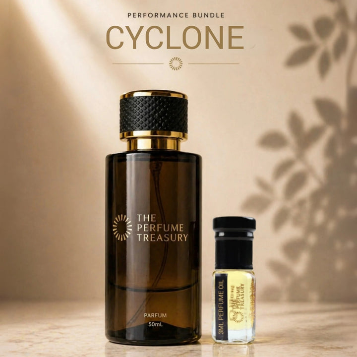 Cyclone Extrait de Parfum bottle surrounded by ginger, citrus fruits, neroli blossoms, black tea leaves, spiced rum, tobacco, cinnamon, vanilla pods, amber resin and creamy woods in a warm masculine fragrance composition.