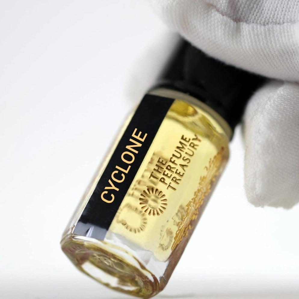 Close-up of Cyclone perfume oil by The Perfume Treasury held in hand, showcasing the premium glass bottle, concentrated fragrance oil and luxury label details.