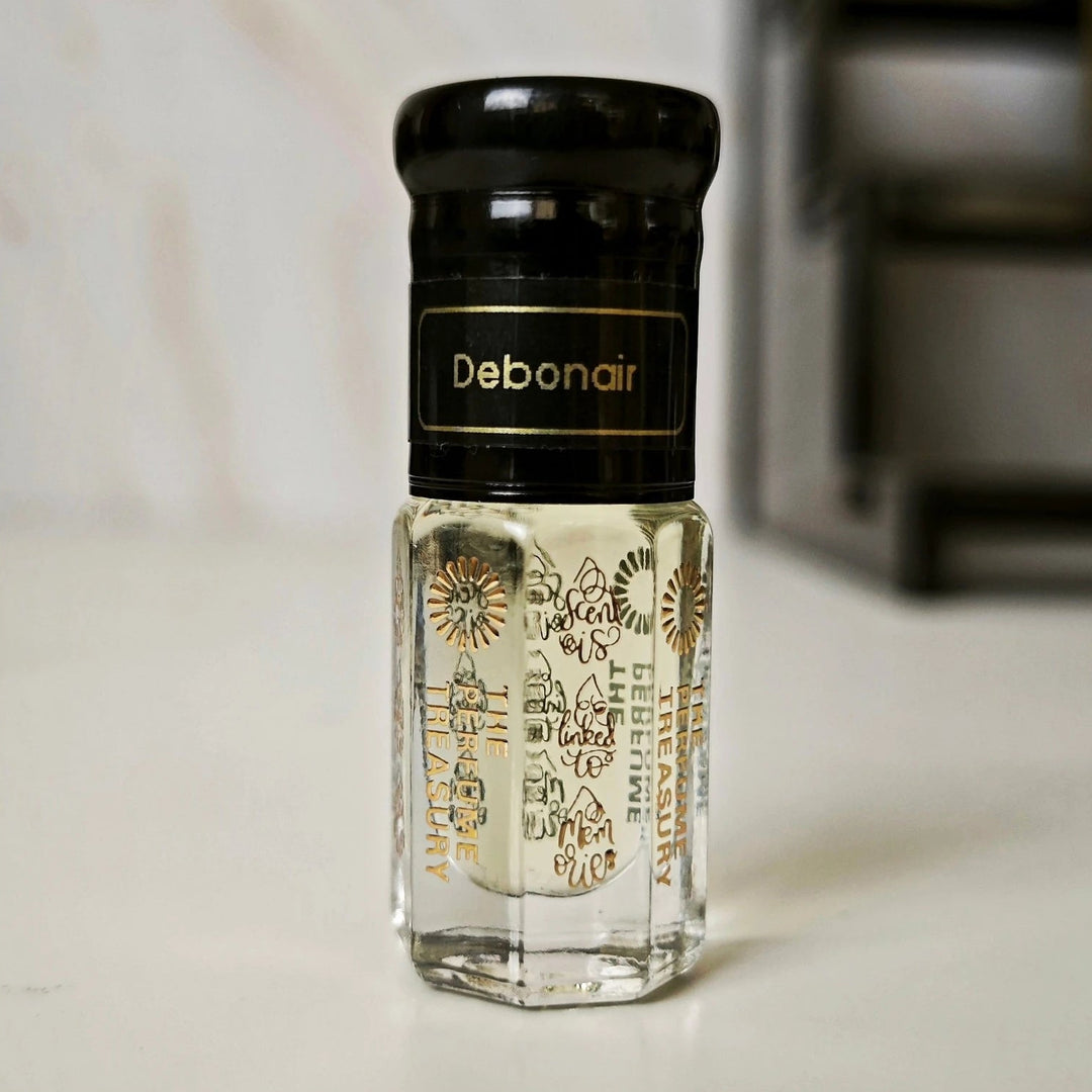 Debonair attar perfume oil 3ml by The Perfume Treasury in clear glass bottle with black cap, luxury fragrance oil on soft neutral background.