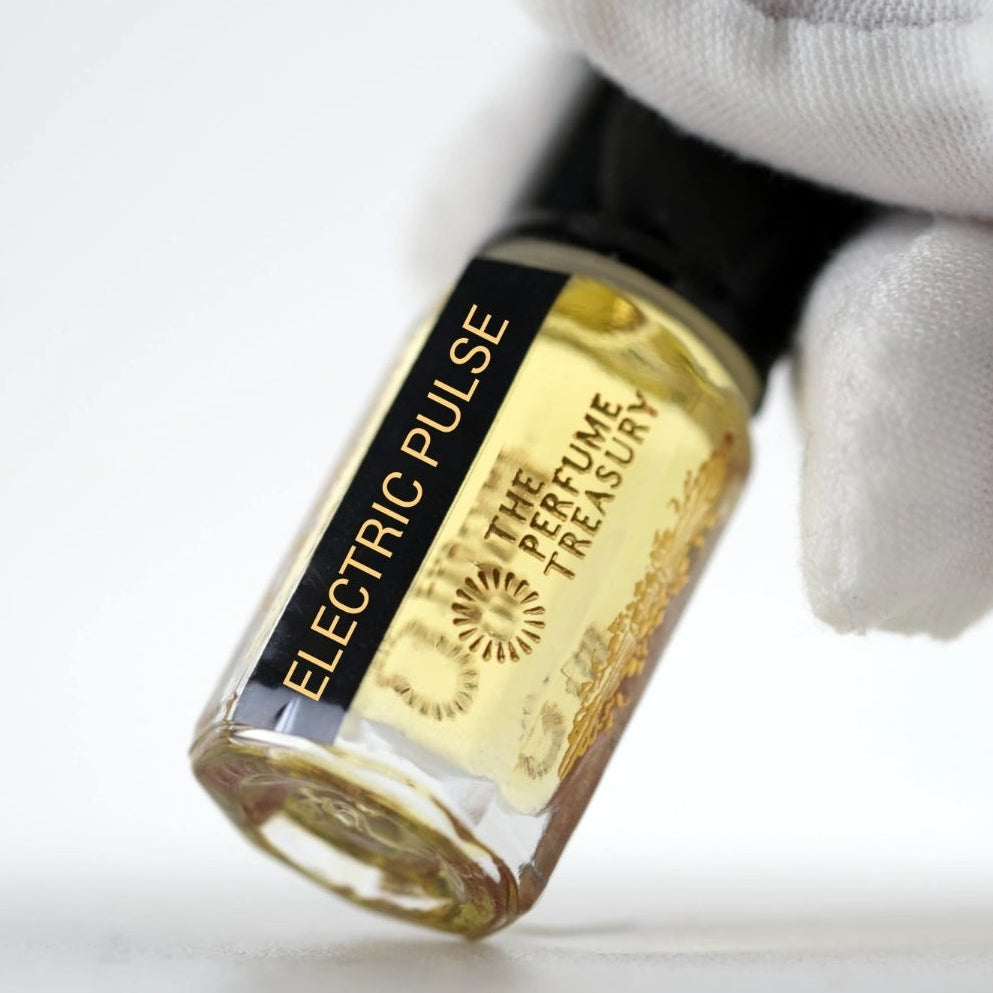 Close-up photograph of Electric Pulse attar perfume oil held in a white glove, showcasing the premium bottle design and luxury fragrance presentation.