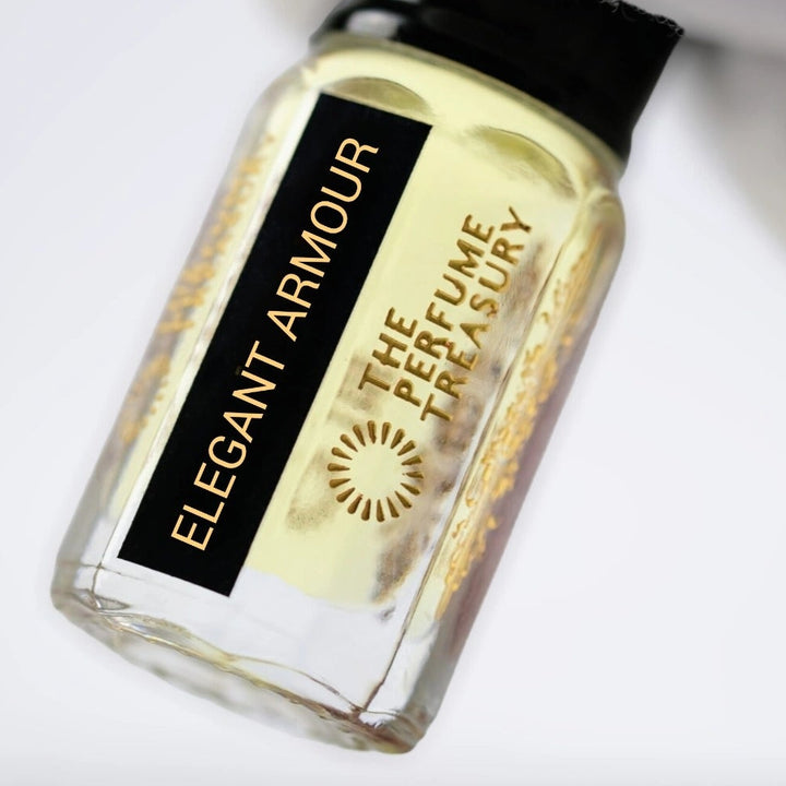 Close-up image of Elegant Armour attar perfume oil by The Perfume Treasury held in a white glove, highlighting the luxury bottle and premium fragrance oil.