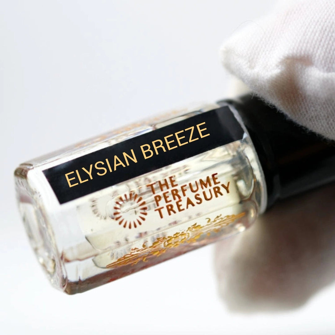 Angled close-up photograph of Elysian Breeze attar perfume oil by The Perfume Treasury held in a white glove, highlighting the premium bottle design and luxury alcohol-free fragrance oil presentation.