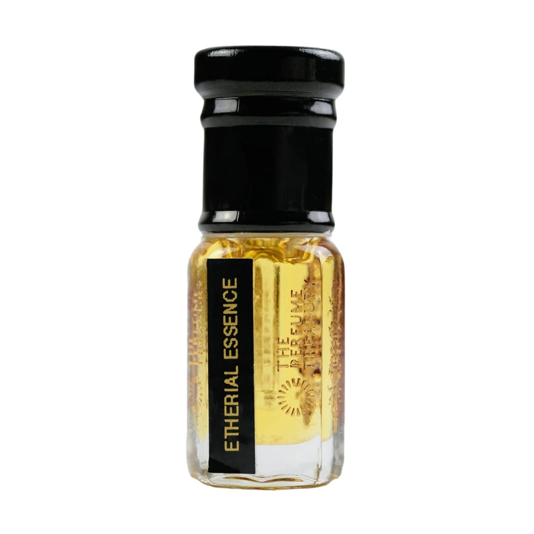 Ethereal Essence attar perfume oil by The Perfume Treasury displayed in a luxury clear glass bottle with black cap and rich golden fragrance oil on a white background for online product listings.