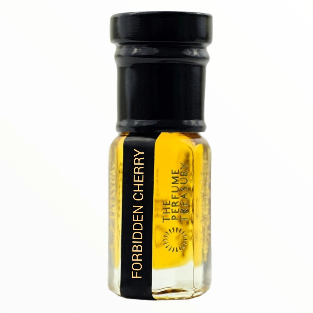 Small clear glass perfume oil bottle with black cap, Forbidden Cherry 3ml attar perfume oil by The Perfume Treasury, vibrant golden-yellow fruity fragrance oil on white background.