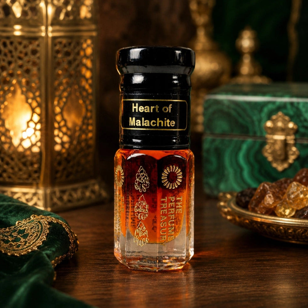 Heart of Malachite Attar Perfume Oil by The Perfume Treasury displayed on a wooden table with an ornate lantern, green malachite-style box, decorative resin and warm ambient lighting.