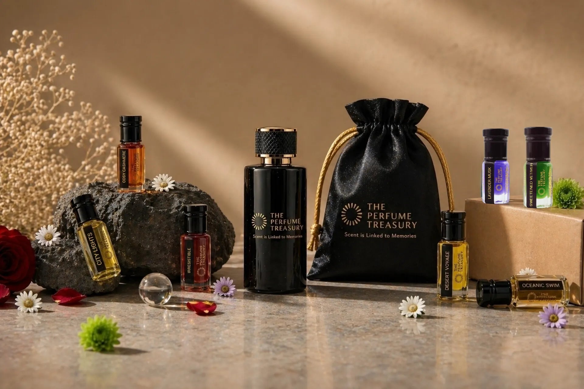 The Perfume Treasury black spray perfume bottle with a branded gift pouch and perfume oils on a warm beige background