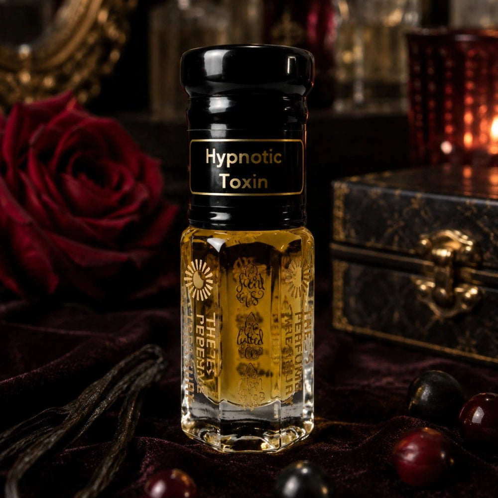 Hypnotic Toxin Attar Perfume Oil by The Perfume Treasury displayed on rich velvet with red roses, vanilla pods, decorative perfume bottles and warm candlelight, creating a luxurious oriental fragrance setting.