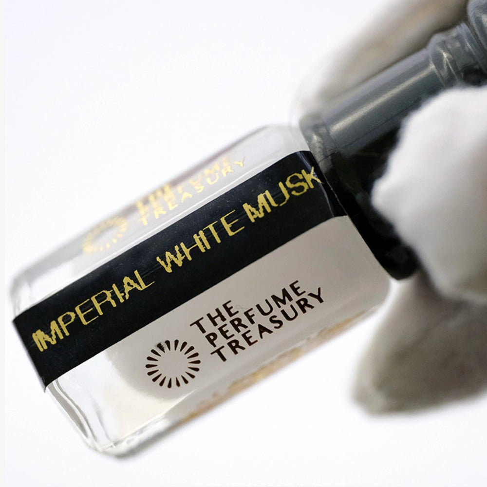 Close-up of Imperial White Musk perfume oil showing clean transparent liquid and refined bottle detail.