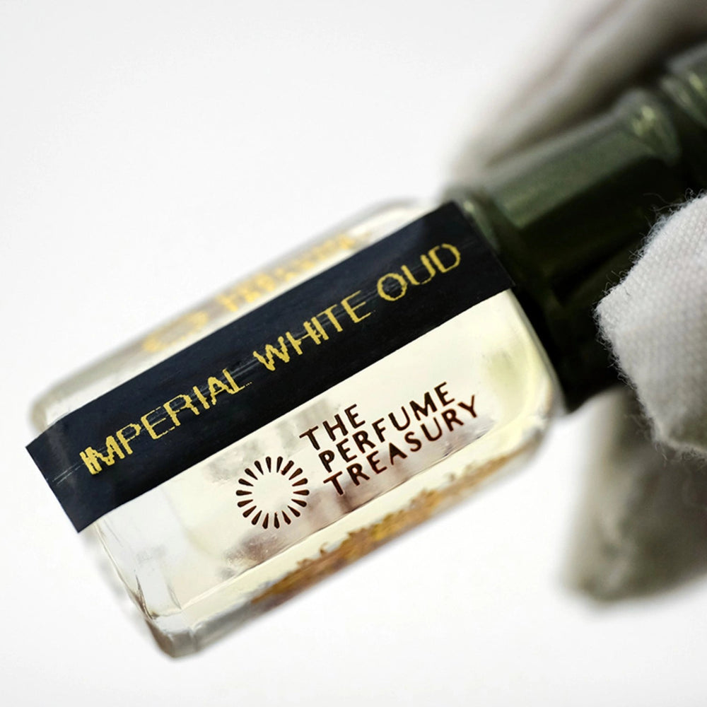 Close-up of Imperial White Oud Attar Perfume Oil by The Perfume Treasury, showing the 3ml glass bottle and branded label.