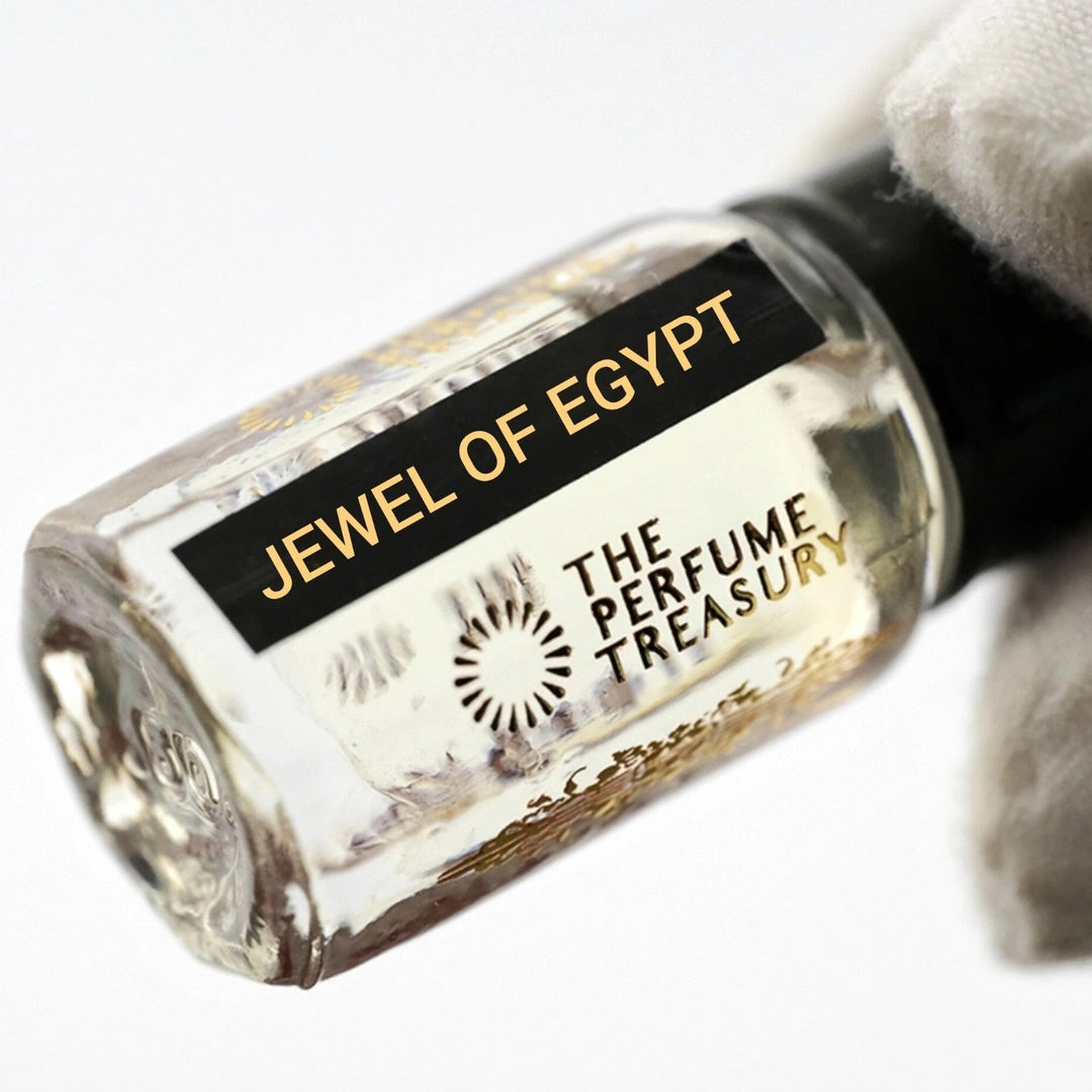 Close-up of Jewel of Egypt Perfume Oil by The Perfume Treasury showing the glass attar bottle and black fragrance label.