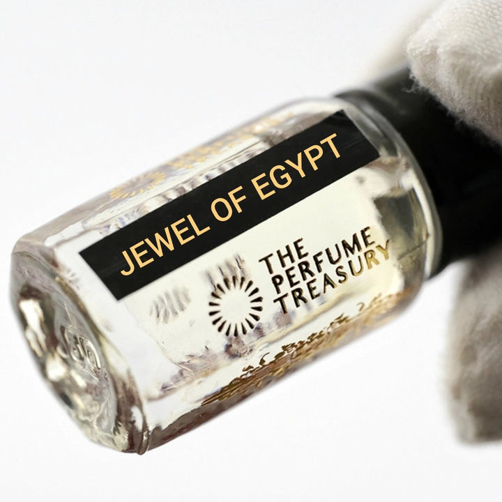 Close-up of Jewel of Egypt Perfume Oil by The Perfume Treasury showing the glass attar bottle and black fragrance label.