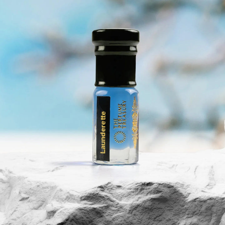 Launderette musk tahara perfume oil by The Perfume Treasury on textured surface with soft blue background, fresh laundry scent body musk.