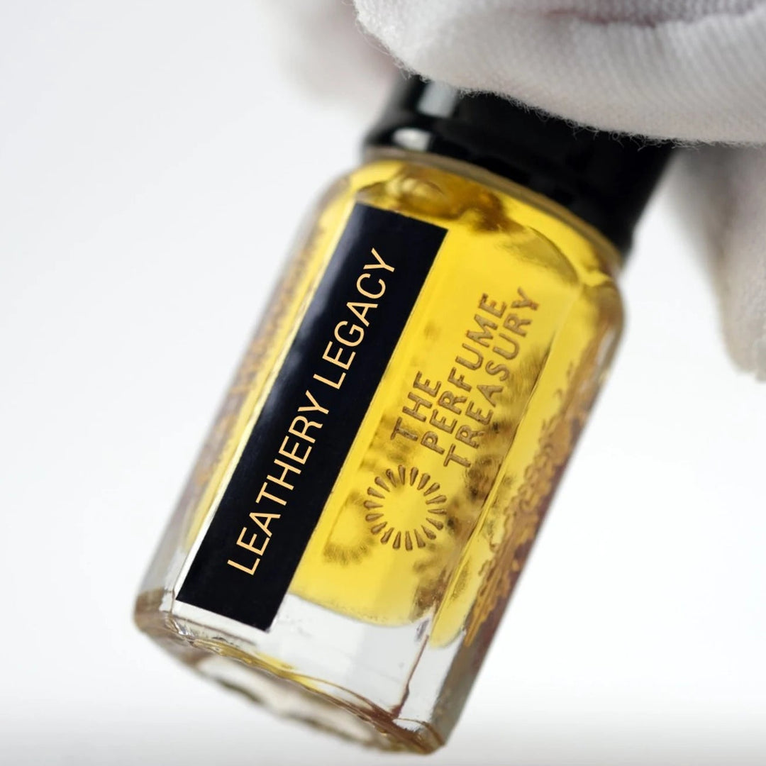 Close-up of Leathery Legacy perfume oil by The Perfume Treasury showing the black and gold label and rich golden oil.