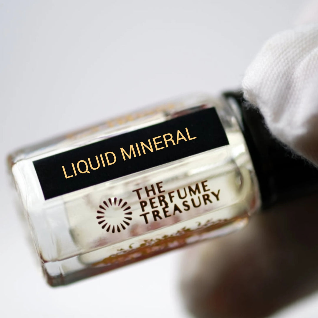 Close-up of Liquid Mineral perfume oil bottle by The Perfume Treasury showing the black and gold label.