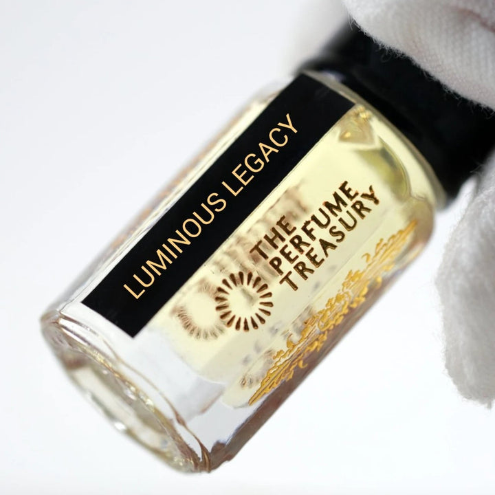 Close-up of Luminous Legacy perfume oil bottle by The Perfume Treasury showing the black and gold label.