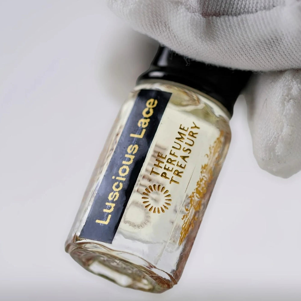 Close-up of Luscious Lace perfume oil bottle by The Perfume Treasury showing the black and gold label.