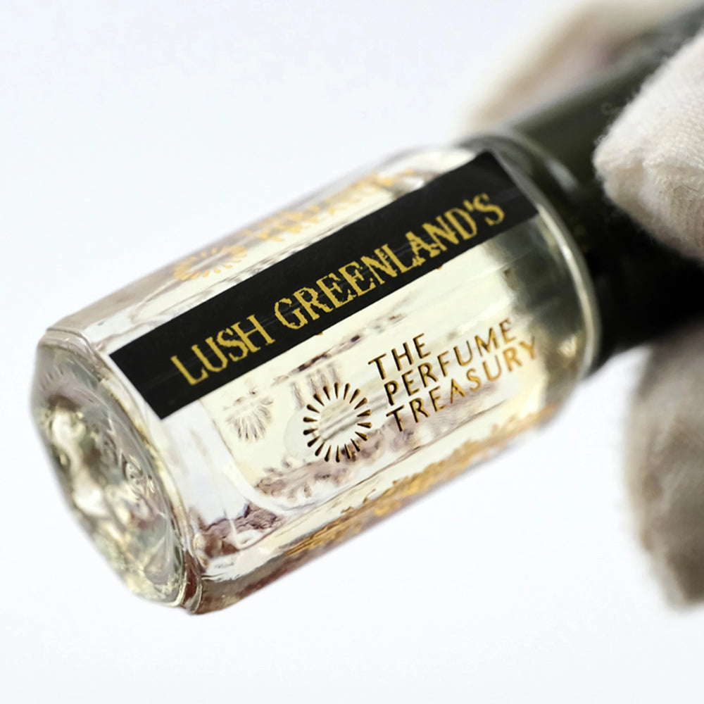 Close-up of Lush Greenlands perfume oil bottle by The Perfume Treasury showing the black and gold label.