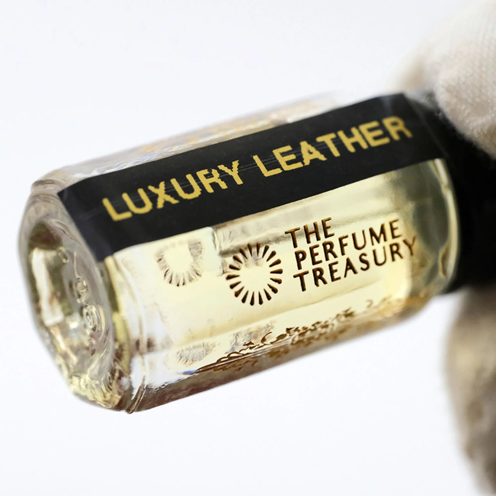 Close-up of Luxury Leather perfume oil bottle by The Perfume Treasury showing the black and gold label.