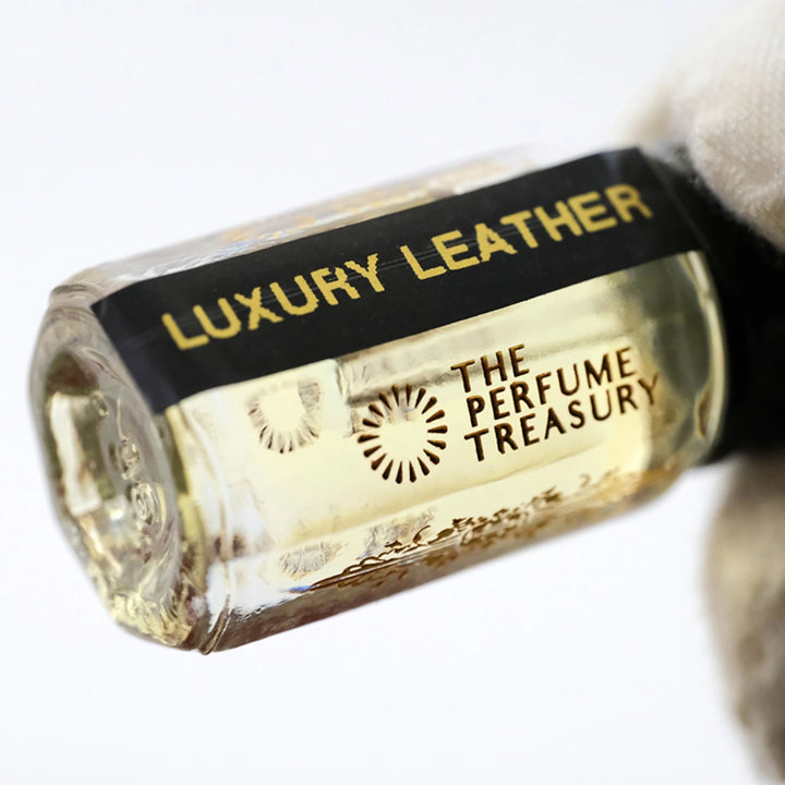 Close-up of Luxury Leather perfume oil bottle by The Perfume Treasury showing the black and gold label.
