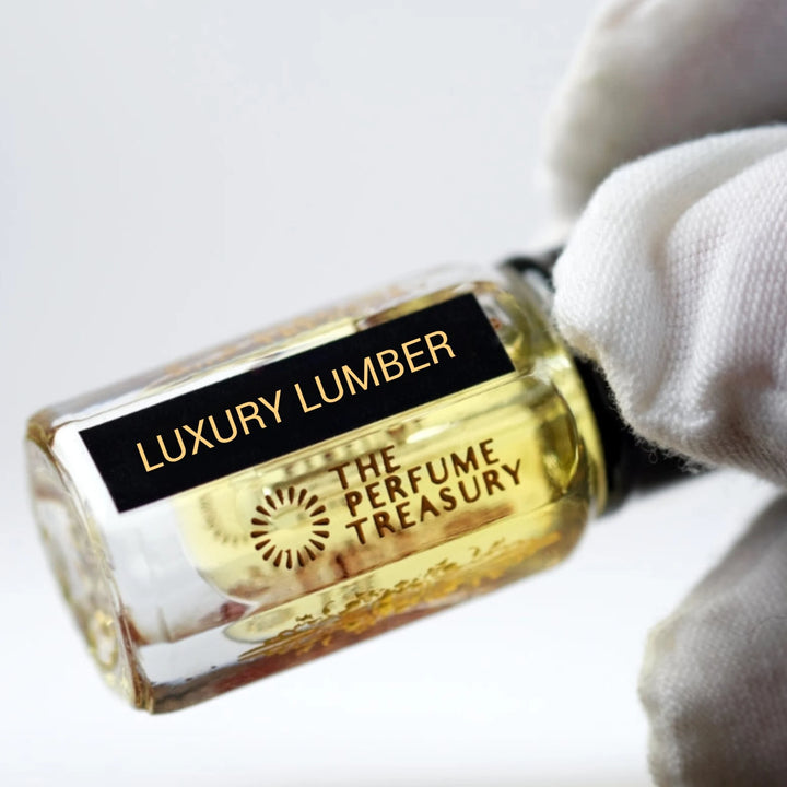 Close-up of Luxury Lumber perfume oil bottle by The Perfume Treasury showing the black and gold label.