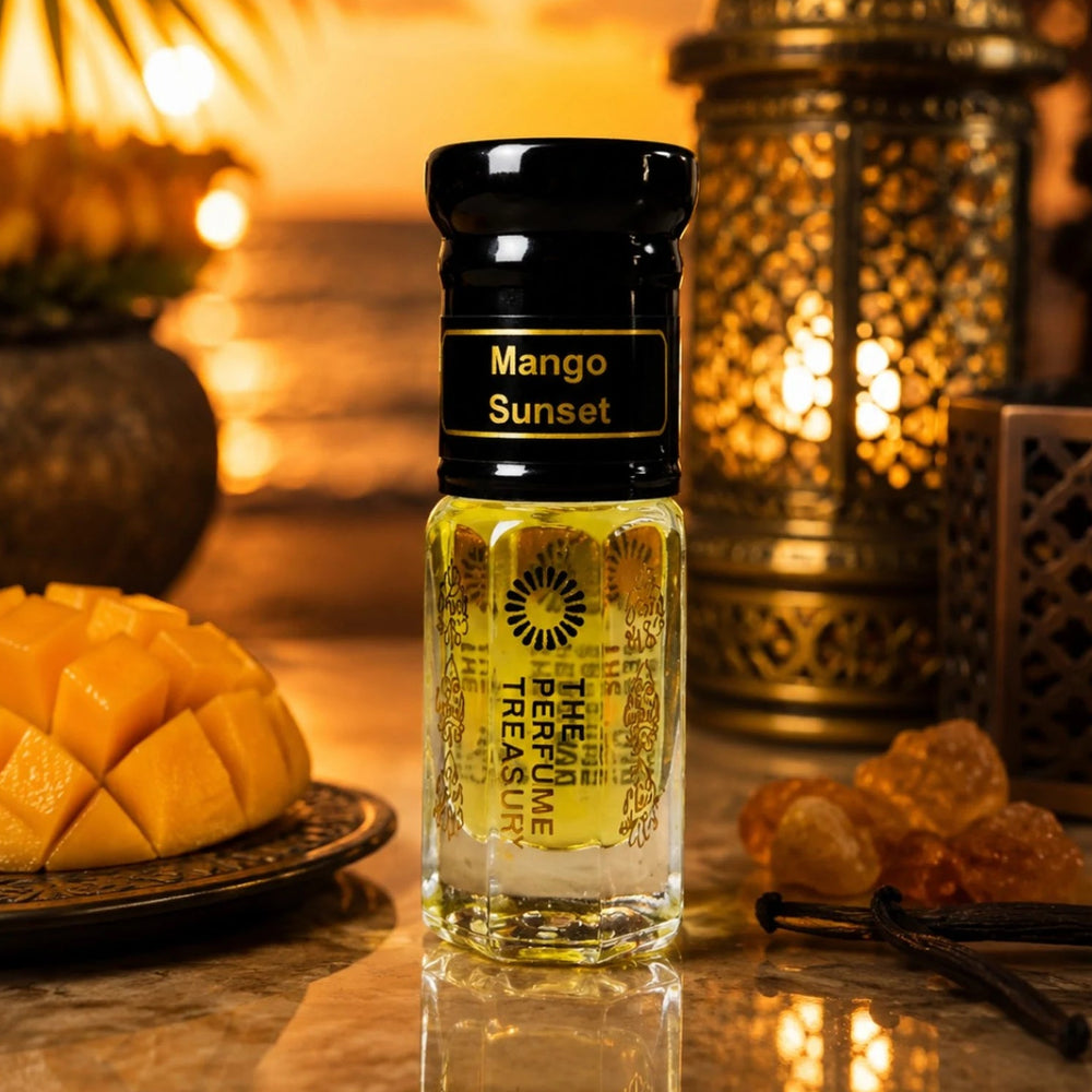 Mango Sunset perfume oil by The Perfume Treasury displayed with fresh mango, vanilla and an ornate lantern against a warm tropical sunset setting.