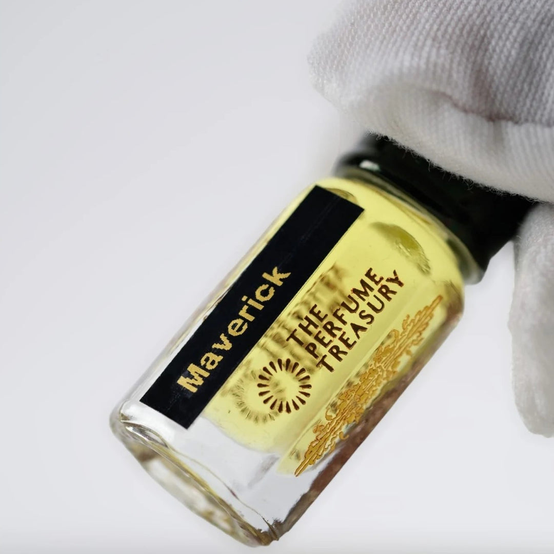 Close-up of Maverick perfume oil by The Perfume Treasury showing the black and gold label and golden perfume oil.