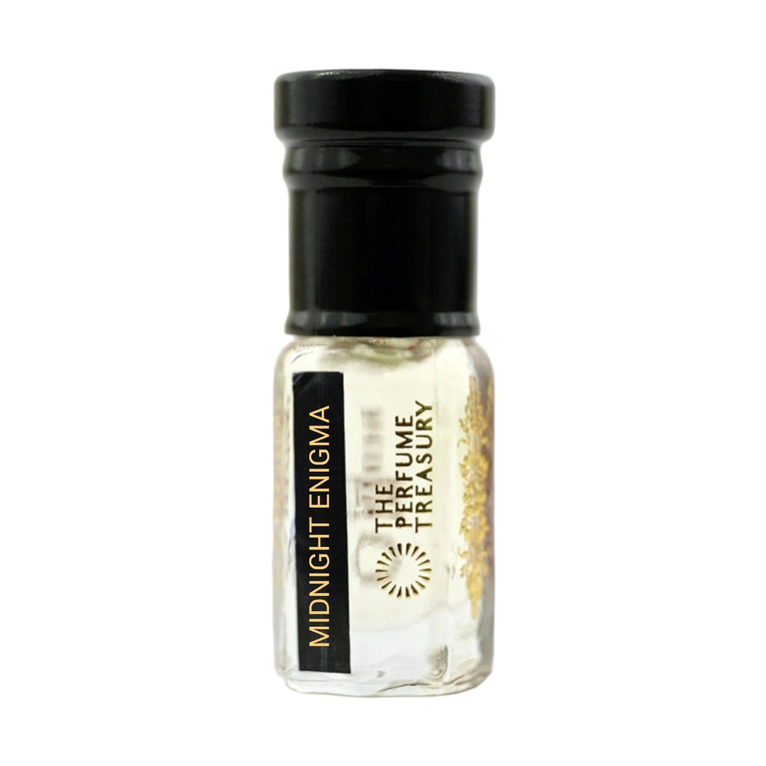 Midnight Enigma perfume oil by The Perfume Treasury in a clear glass attar bottle with black cap and pale fragrance oil.