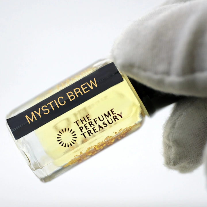 Close-up of Mystic Brew perfume oil by The Perfume Treasury showing the black and gold label and pale golden perfume oil.