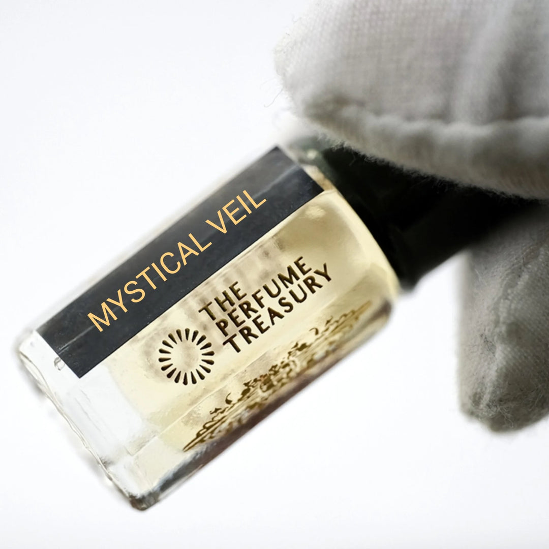 A close-up of a perfume oil bottle labeled &