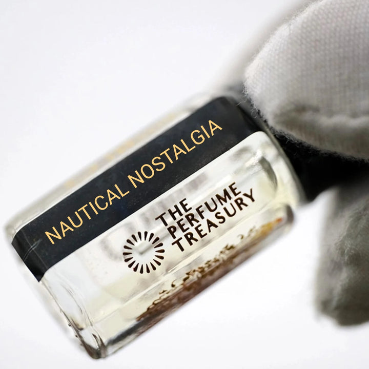Close-up of Nautical Nostalgia perfume oil by The Perfume Treasury showing the black and gold label and clear fragrance oil.