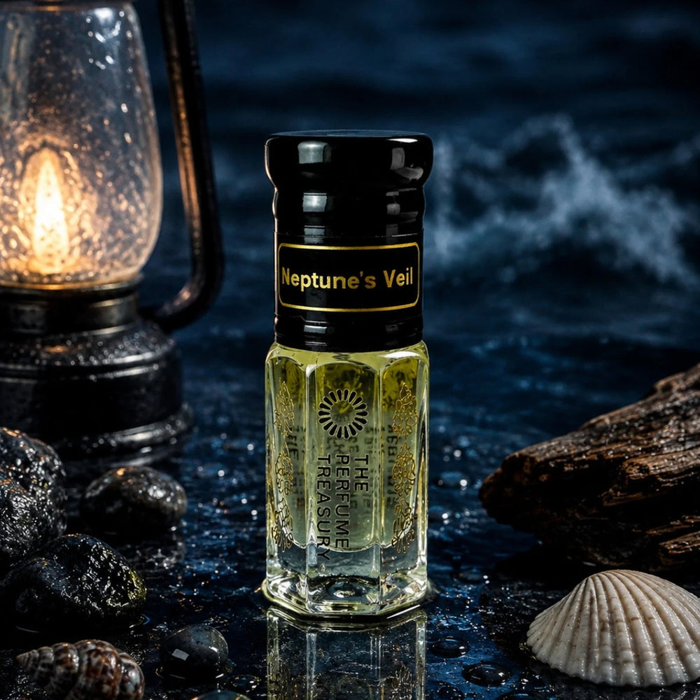 Neptune's Veil perfume oil by The Perfume Treasury in a dark ocean-inspired setting with wet stones, seashells, driftwood and a glowing lantern.