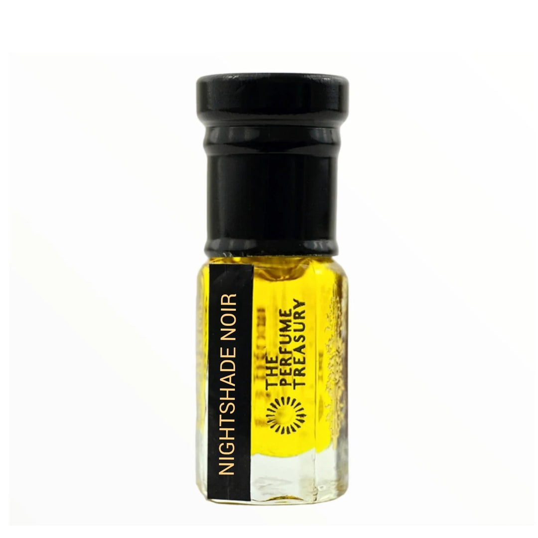 Nightshade Noir perfume oil by The Perfume Treasury in a clear glass attar bottle with black cap and rich golden fragrance oil.