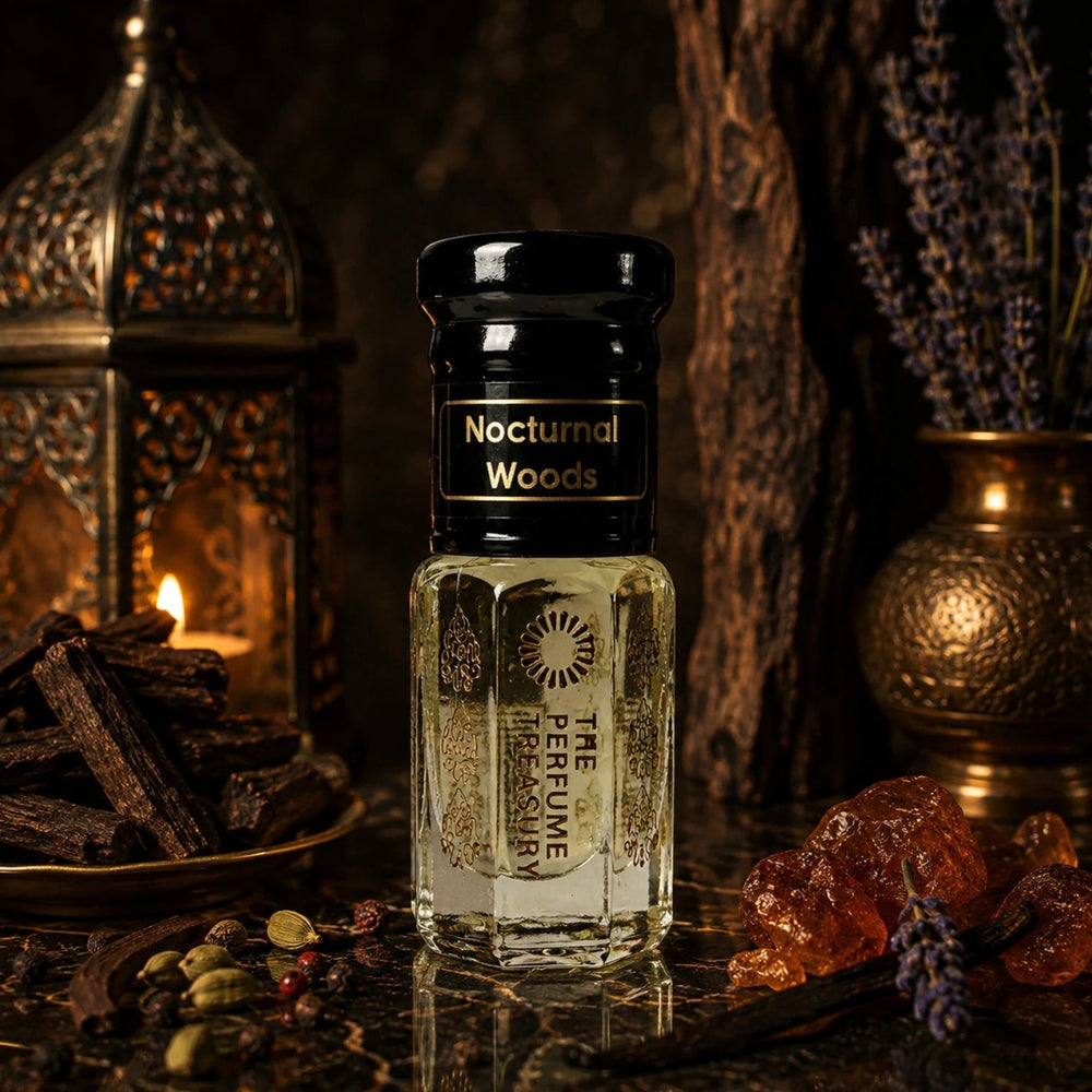 Nocturnal Woods perfume oil by The Perfume Treasury displayed in a dark luxurious setting with oud wood, warm amber resin, cardamom, lavender and glowing lantern light.