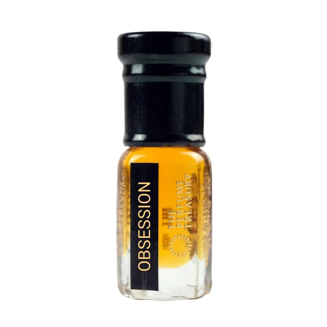 Obsession perfume oil by The Perfume Treasury in a clear glass attar bottle with black cap and rich amber-golden fragrance oil.