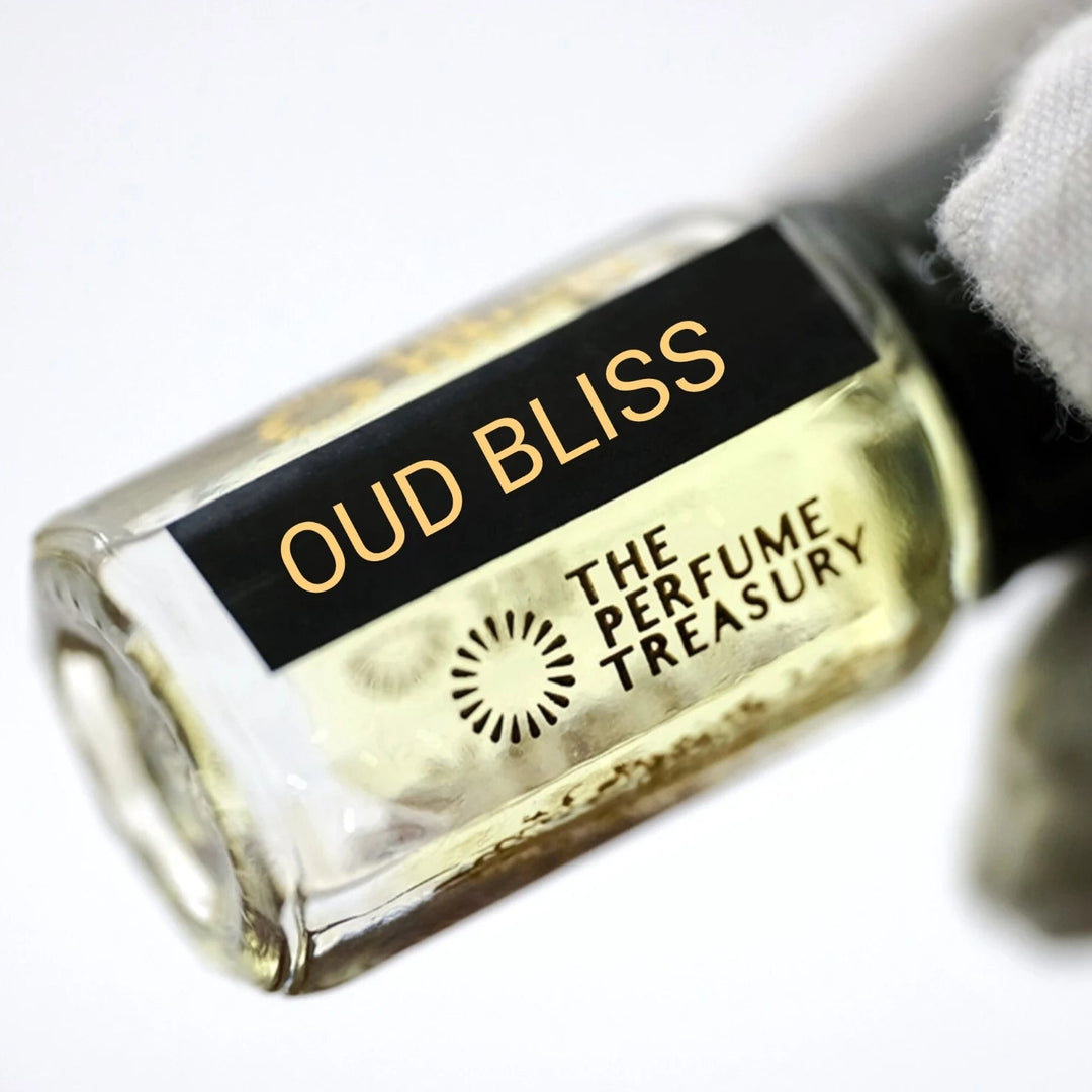 A close-up of a perfume oil bottle labeled &